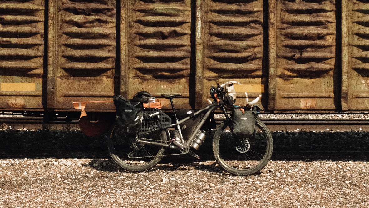 Bicycle beside a freight train